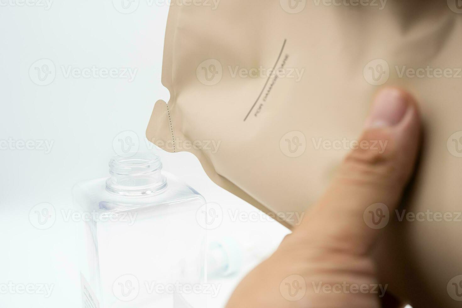 A man fills a dispenser with liquid soap by pouring it from a refill to reduce plastic waste. Soap or Shampoo for refill. photo