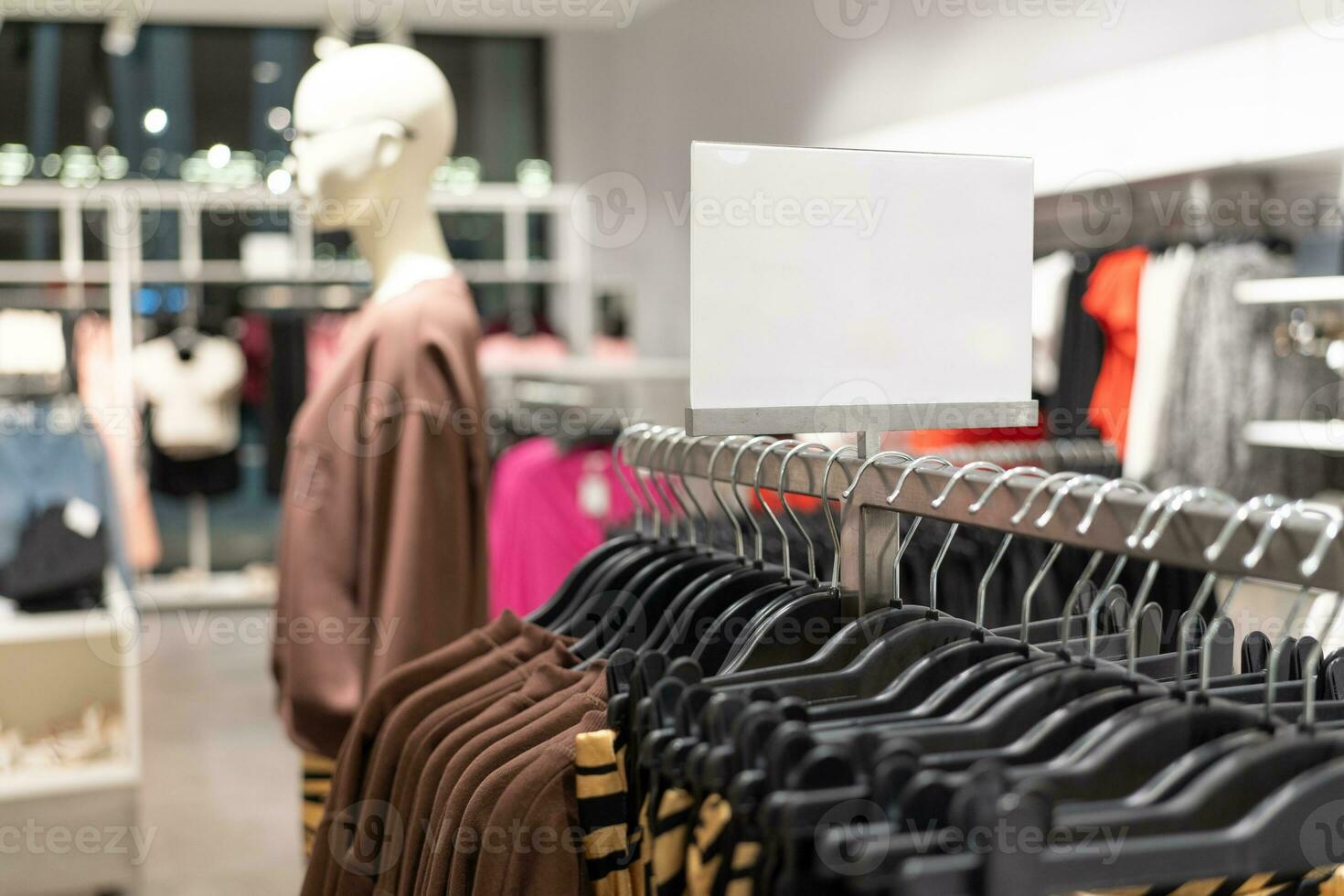 blank sign inside shopping mall. mock up advertise display frame setting over the clothes line in the shopping department store for shopping, business fashion and advertisement concept. photo