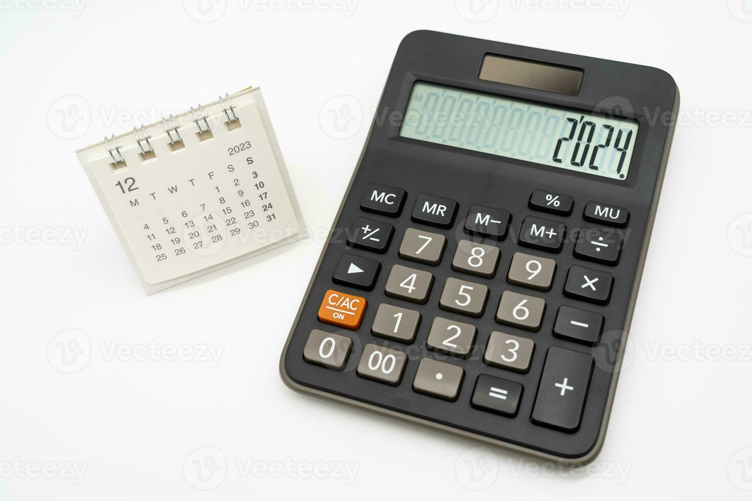 Calculator with the number 2024 on the display and Calendar DEC 2023. Concept of finance, taxes, savings and economic crisis. schedule, timetable and management of job. Business and tax concept. photo