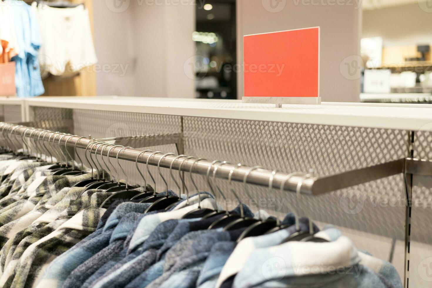 red blank sign inside shopping mall. mock up advertise display frame setting over the clothes line in the shopping department store for shopping, business fashion and advertisement concept. photo