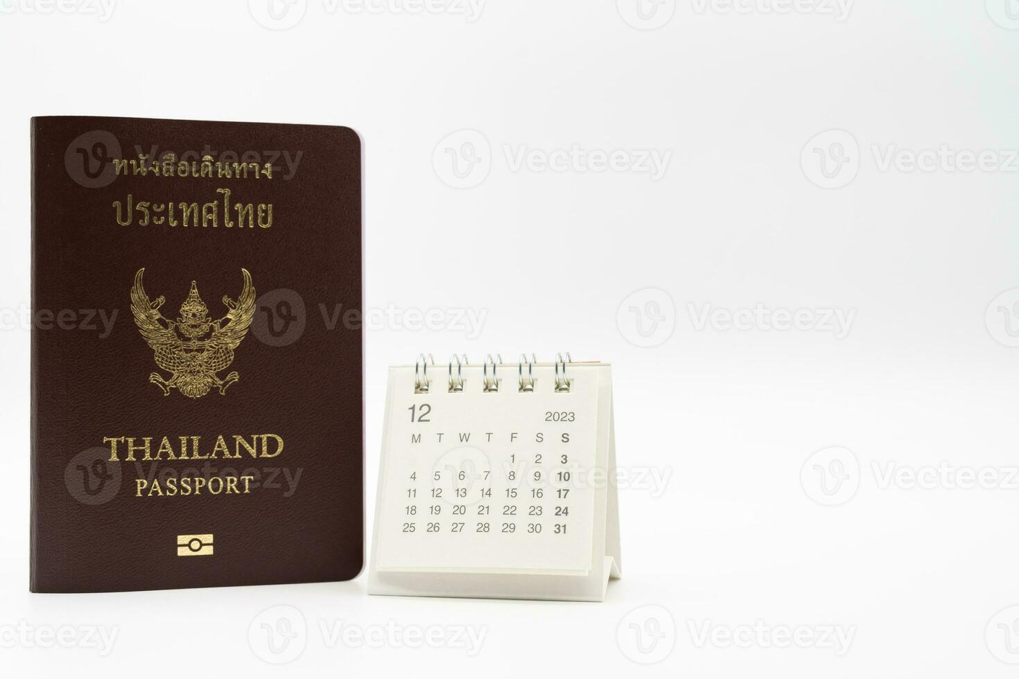 Simple desk calendar for December 2023 and Passport. Calendar and holiday concept with passport isolate on white background. photo