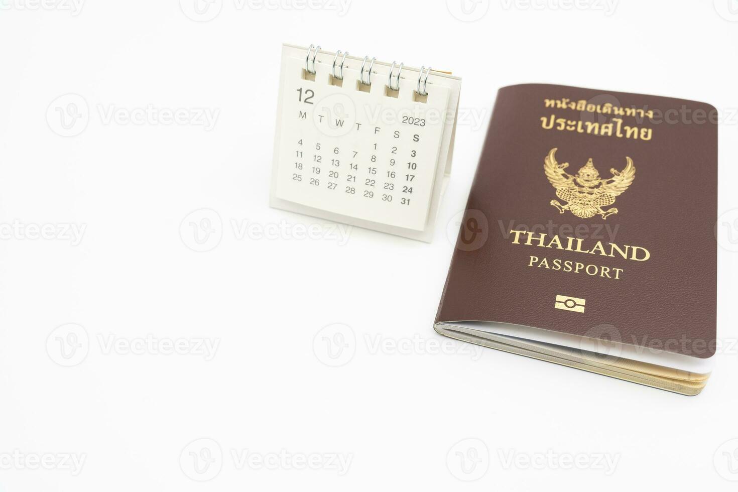 Simple desk calendar for December 2023 and Passport. Calendar and holiday concept with passport isolate on white background. photo