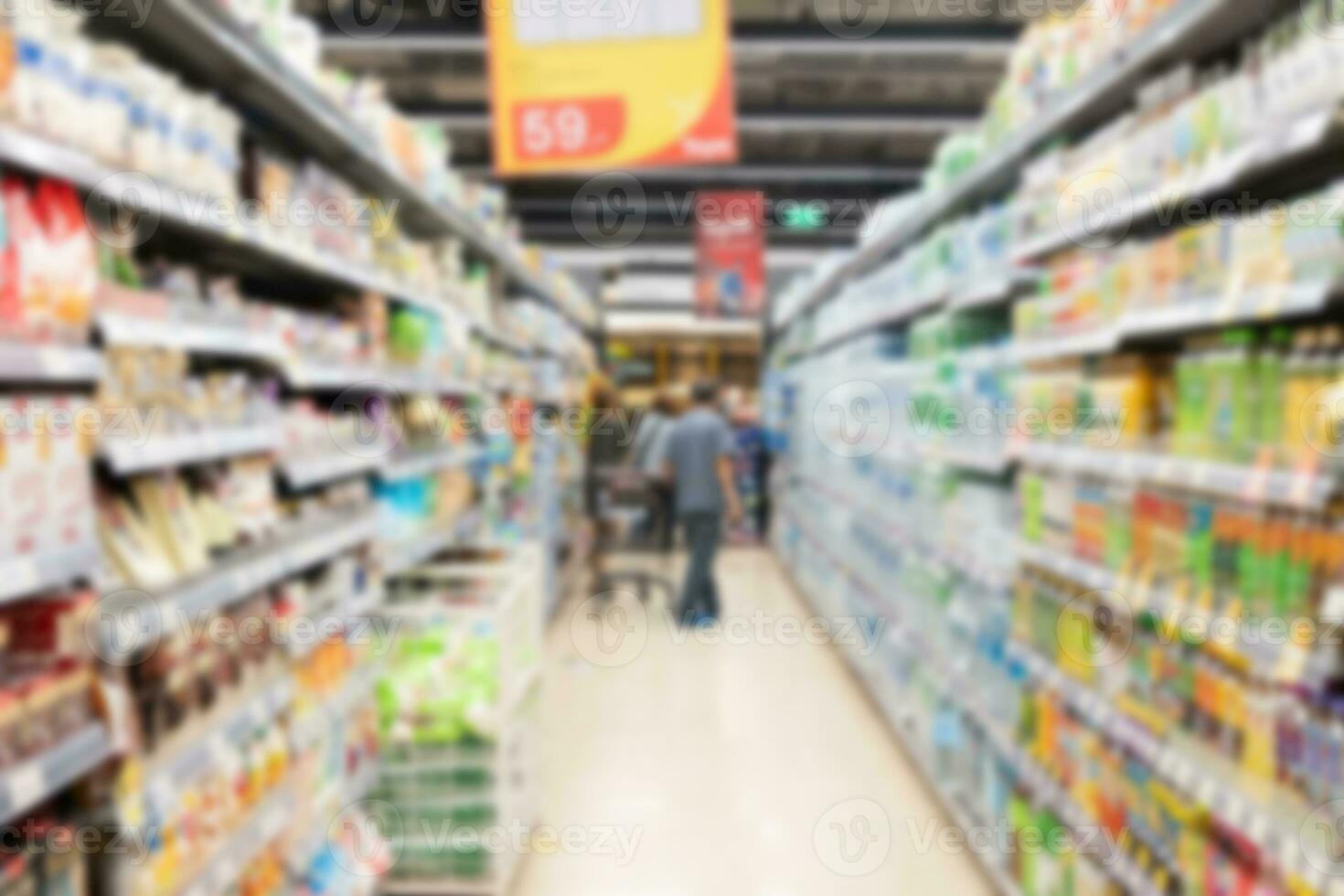 Abstract blurred supermarket aisle with colorful shelves in shopping mall interior for background, Blurred background and unrecognizable customers as background. photo