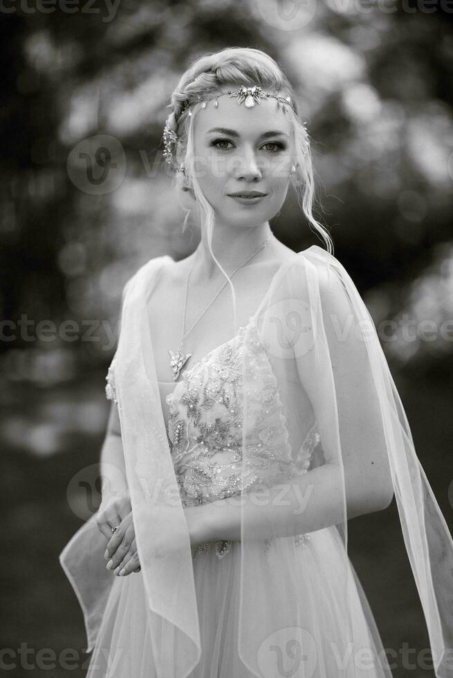 portrait of a happy bride in a light light dress in  wearing elven accessories photo