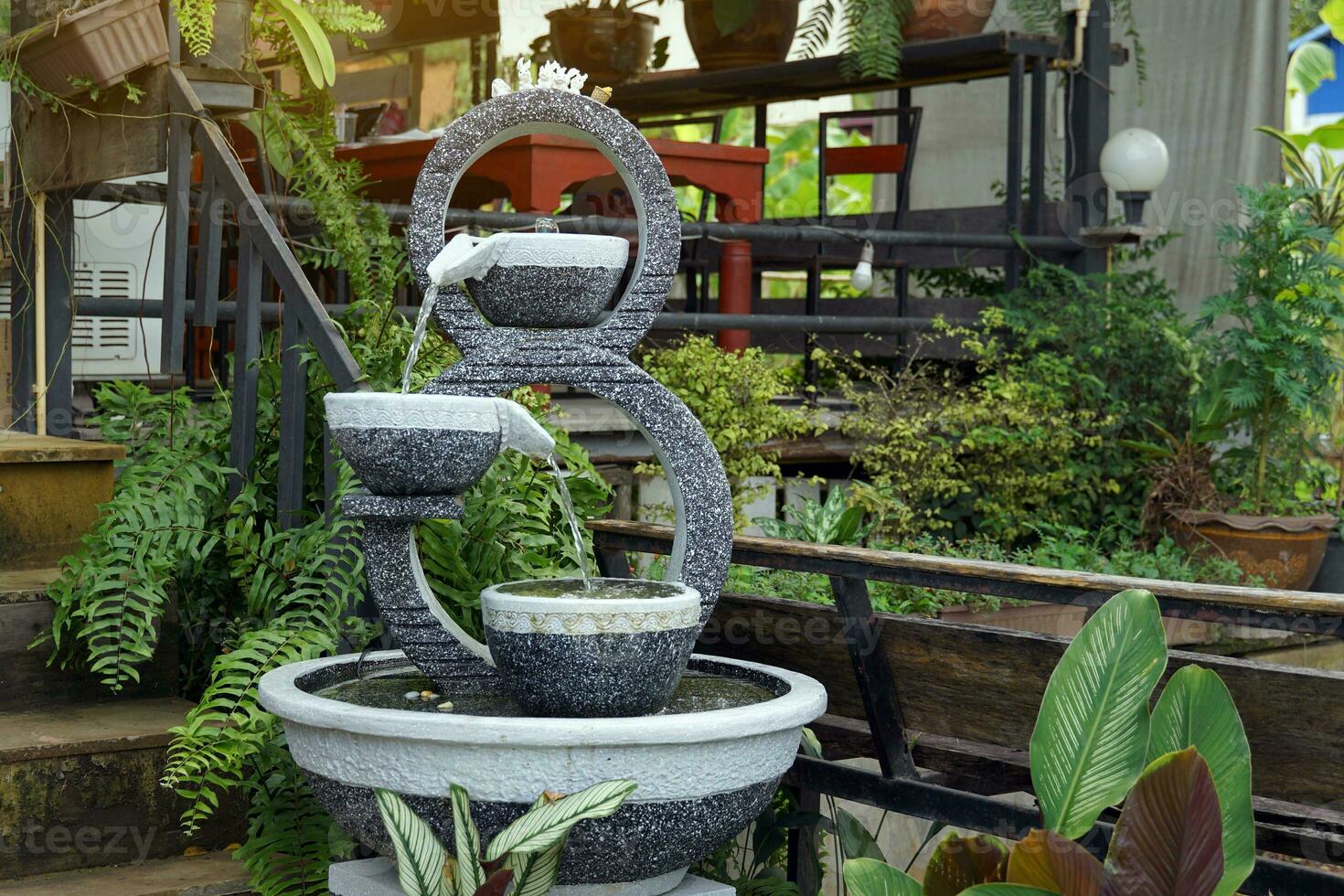 A set of overflowing water in the shape of a number 8, made from fresh stucco with a stone pattern, used to decorate a garden in a natural style to make it beautiful according to Feng Shui principles. photo