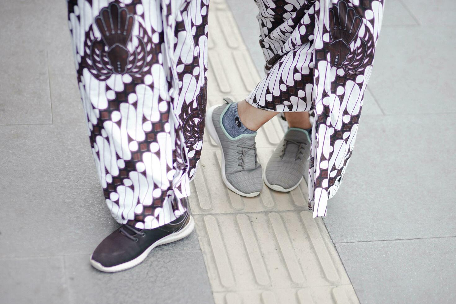 a person wearing a pair of sneakers and a pair of pants photo