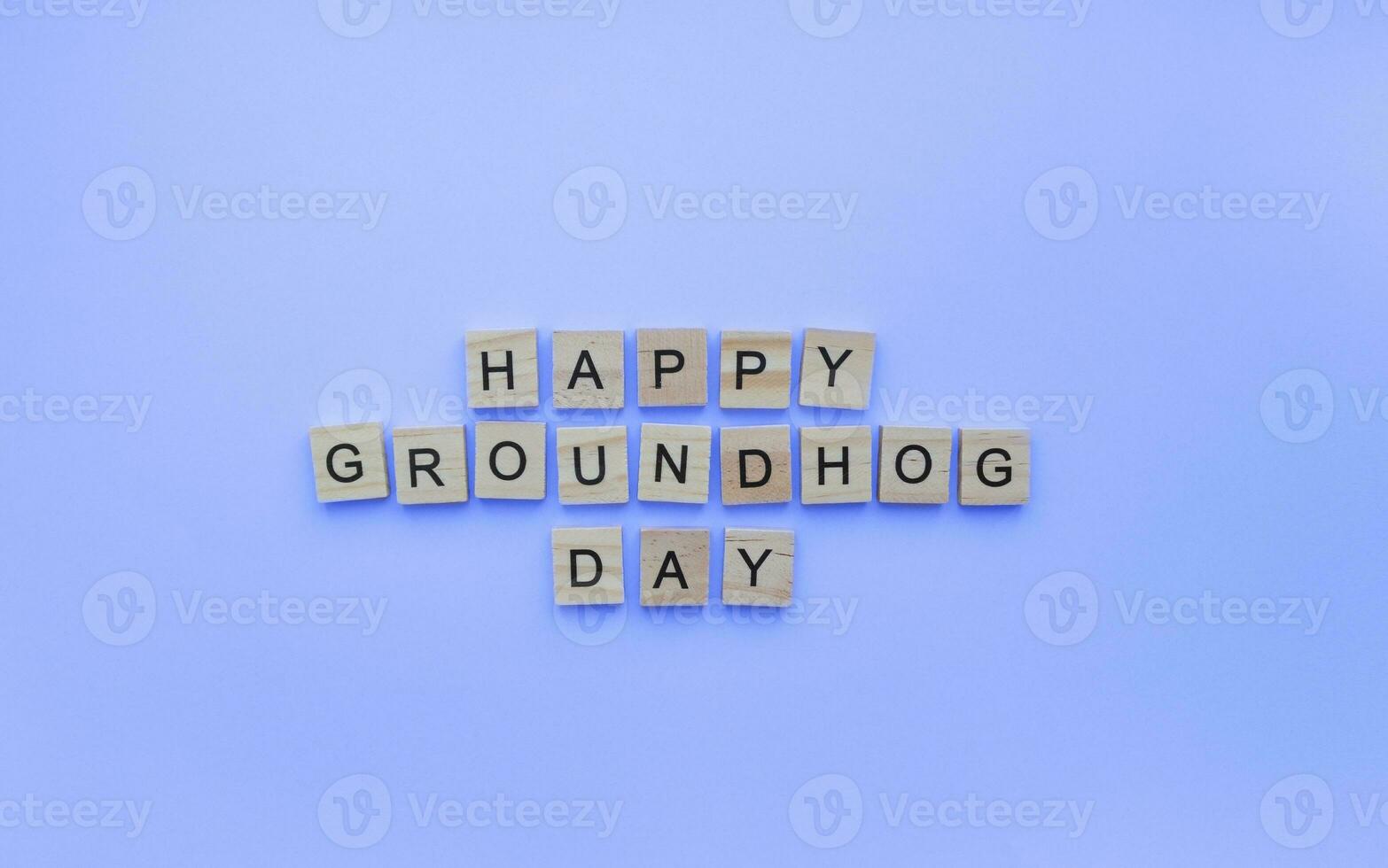 February 2, Groundhog Day, minimalistic banner with the inscription in wooden letters on a blue background photo