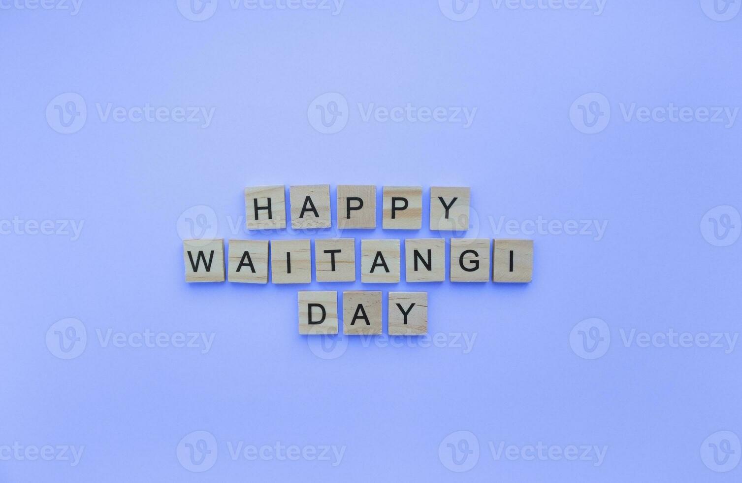 On February 6, happy Waitangi day, a minimalistic banner with an inscription in wooden letters photo