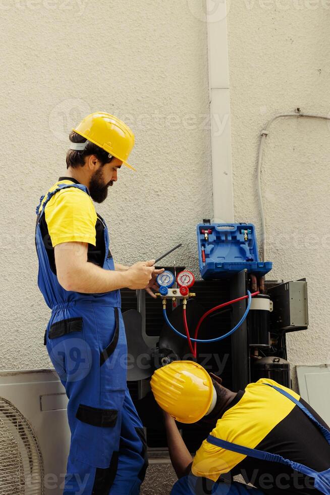 Competent mechanics fixing faulty blower fan causing frozen evaporator