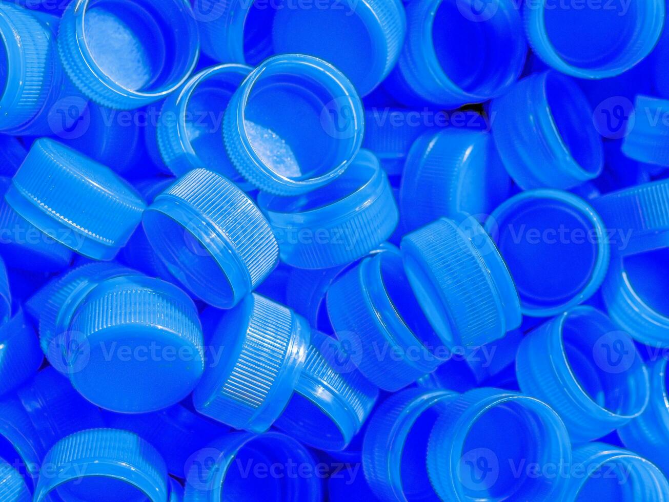 Top view Blue plastic bottle caps.Recycling collection and production processing plastic bottle caps background photo