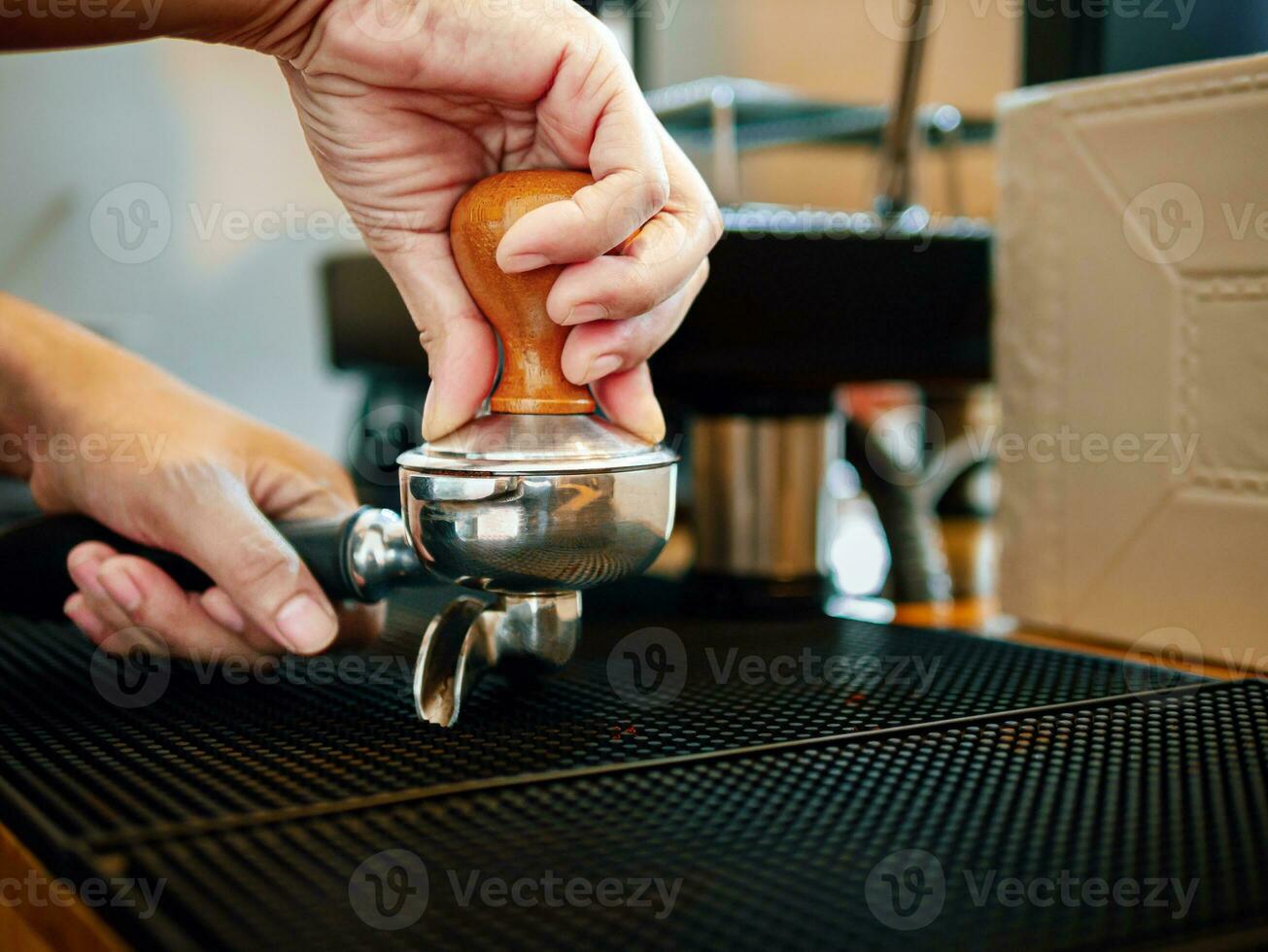 Close-up of hand Barista cafe making coffee with manual presses ground  coffee using a tamper at the coffee shop 27393656 Stock Photo at Vecteezy