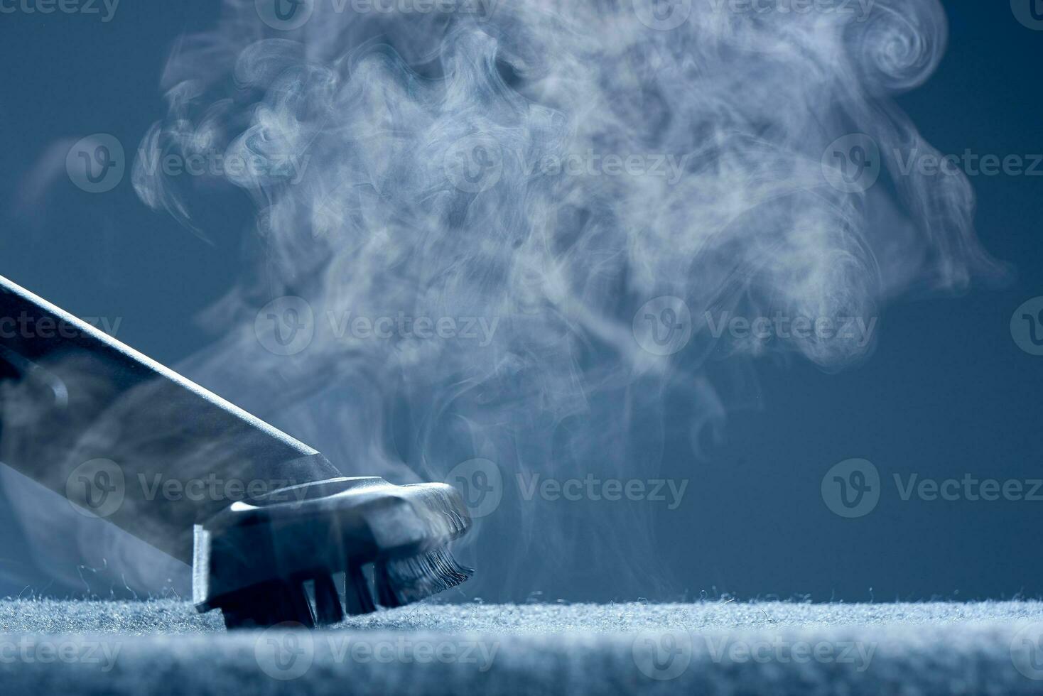 Home cleaning. Steam carpet cleaning on a grey background. Photo with copy space.