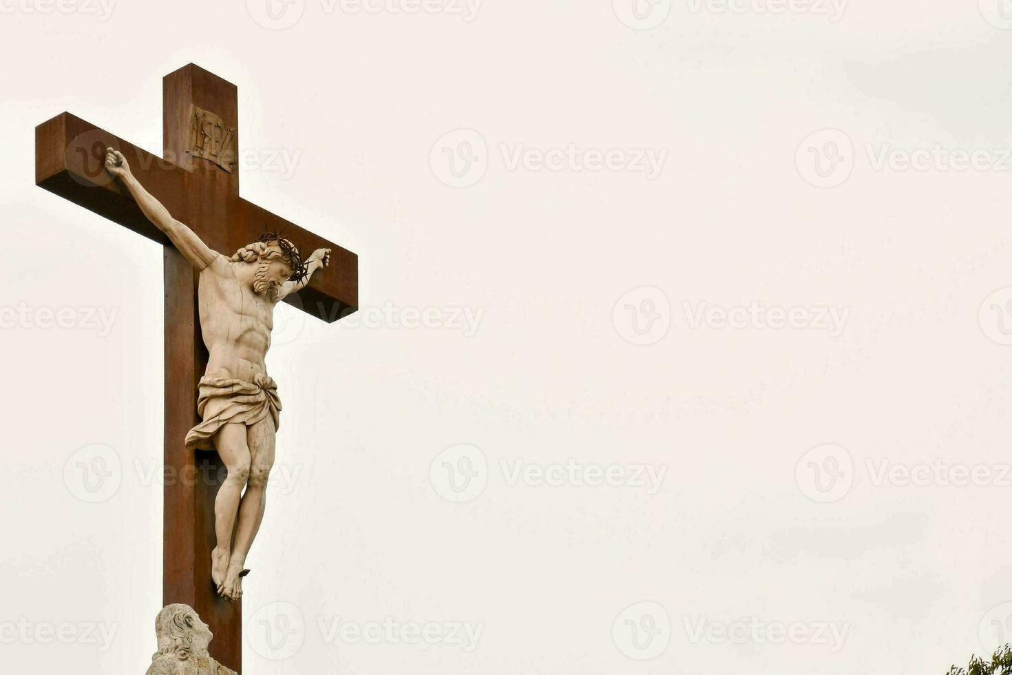 a wooden cross with a man on it photo
