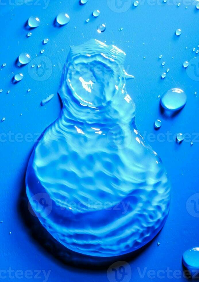 a blue liquid is sitting on top of a blue surface photo