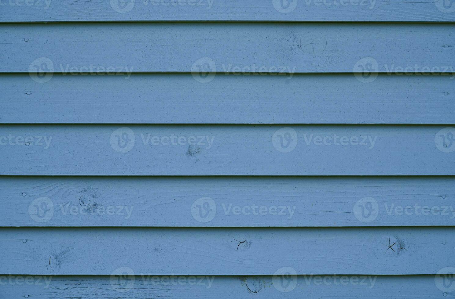 Blue wood background. The wall of the house made of blue wooden boards. photo