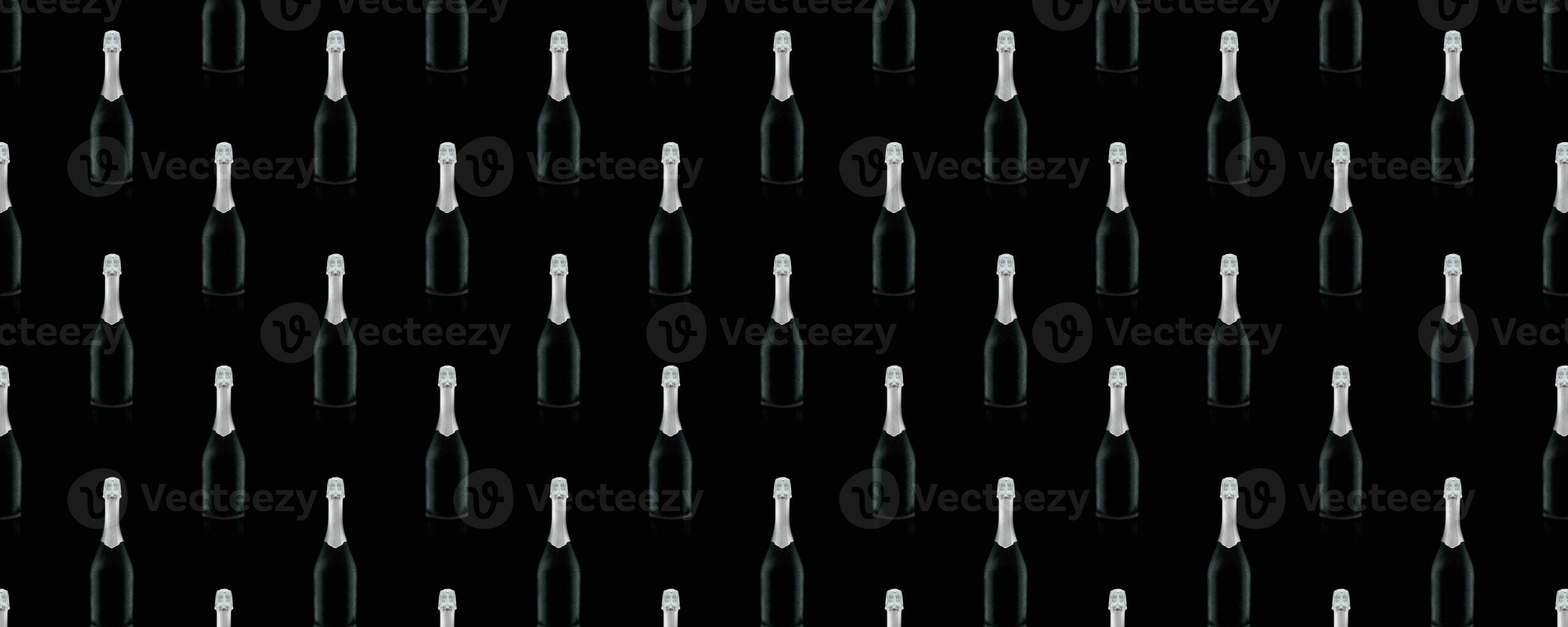 Seamless pattern of black wine bottles with a silver top on a black background. photo