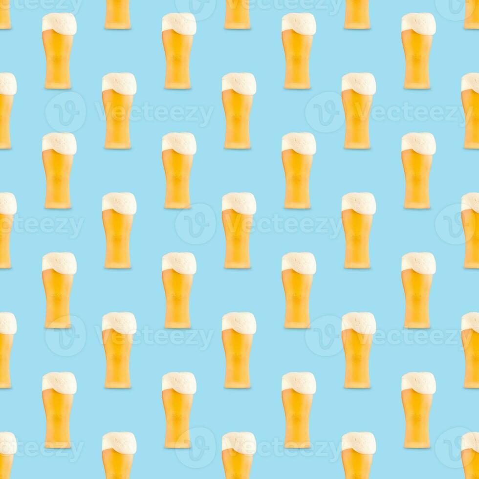 Seamless pattern of large beer glass full of beer with foam on blue background. photo