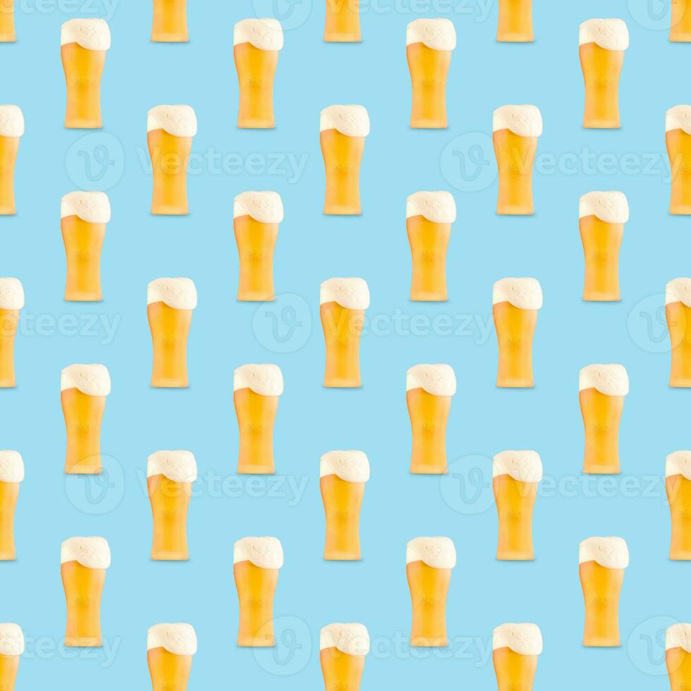 Seamless pattern of large beer glass full of beer with foam on blue background. photo