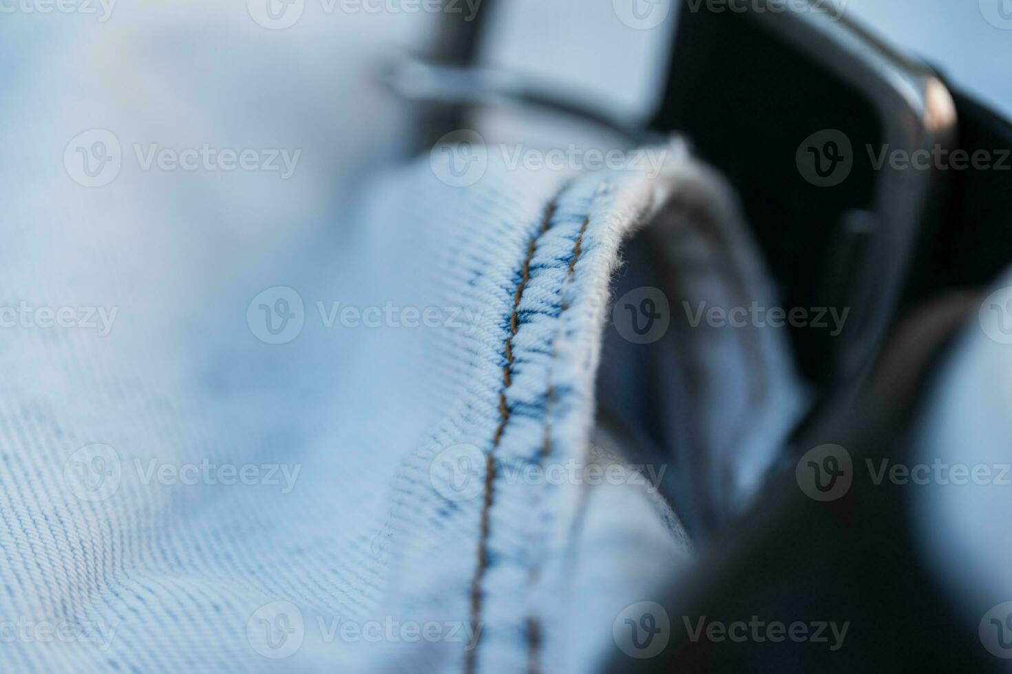 Blue jeans, macro. fashion denim textile and leather belt photo