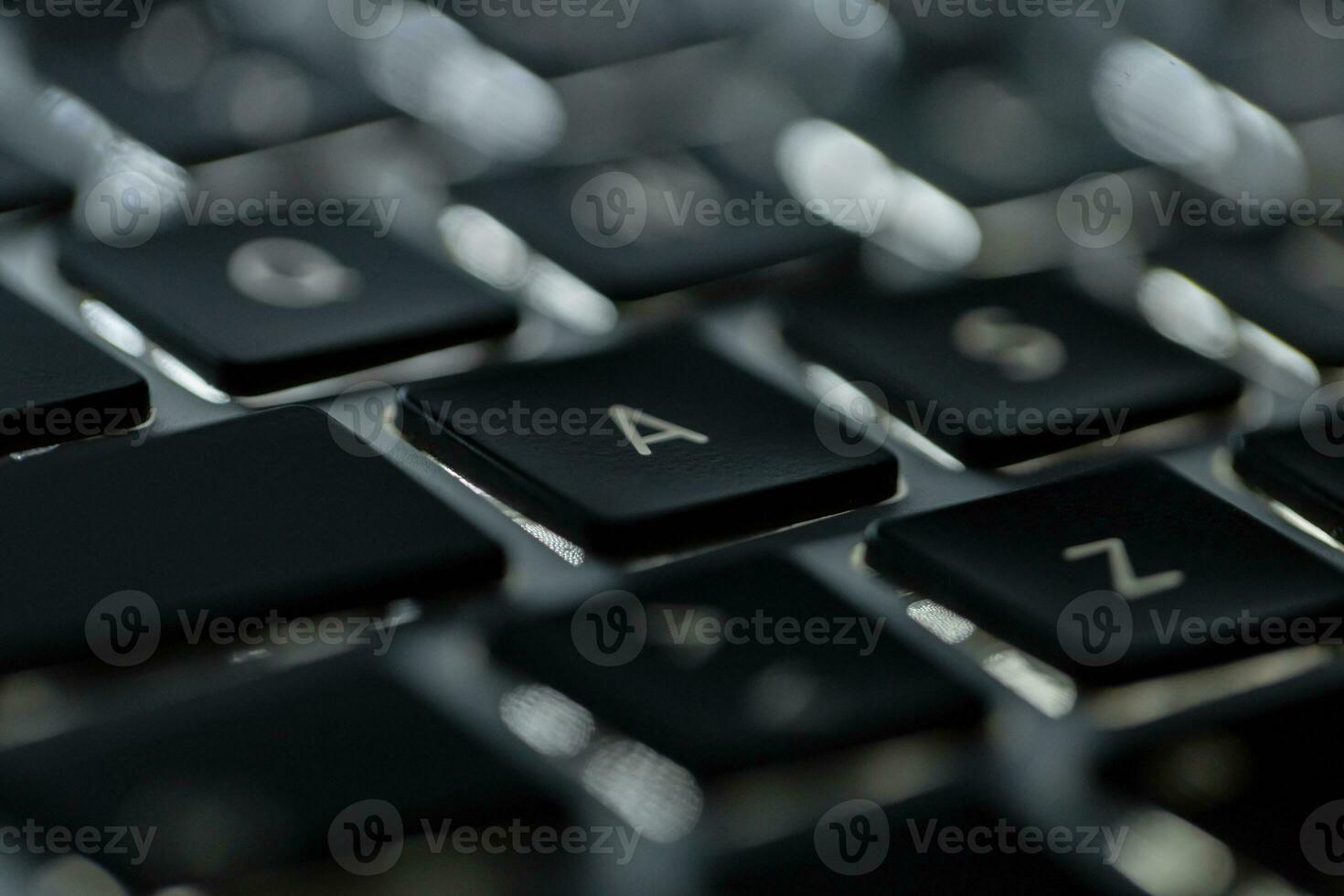 Backlit laptop keyboard, macro. Hacker and technology concept photo
