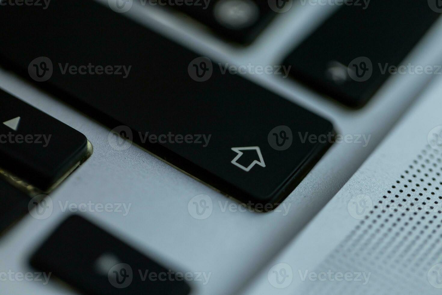 Shift button on the laptop keyboard, close-up photo