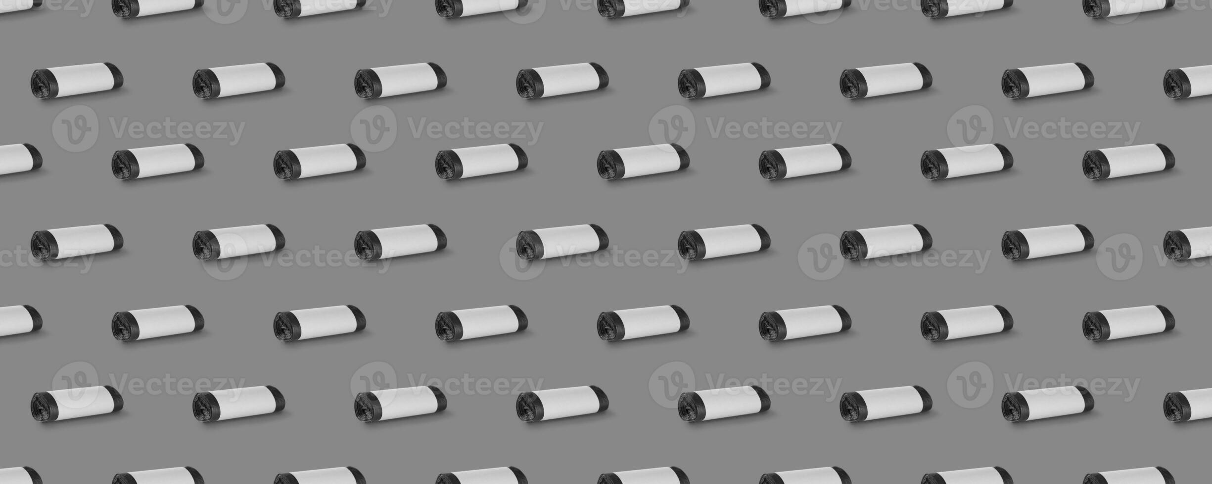 Horizontal seamless pattern. Rolls of garbage bags isolated on gray background. On the roll white copy space. photo