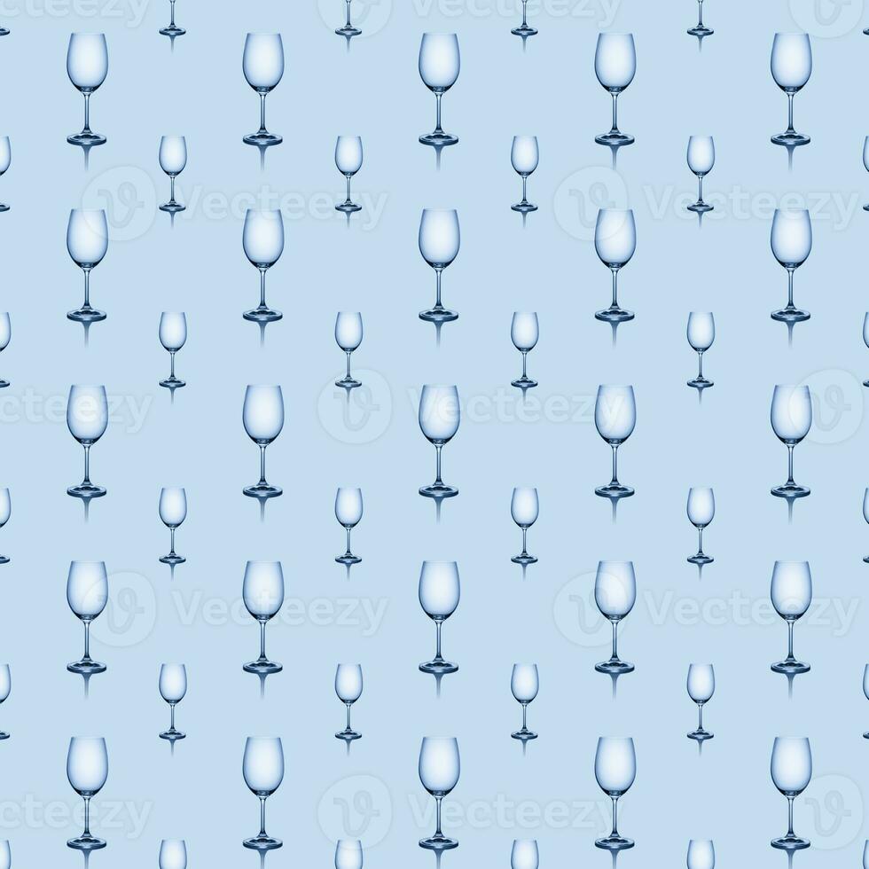 Seamless pattern of empty wine glasses on a blue background. photo