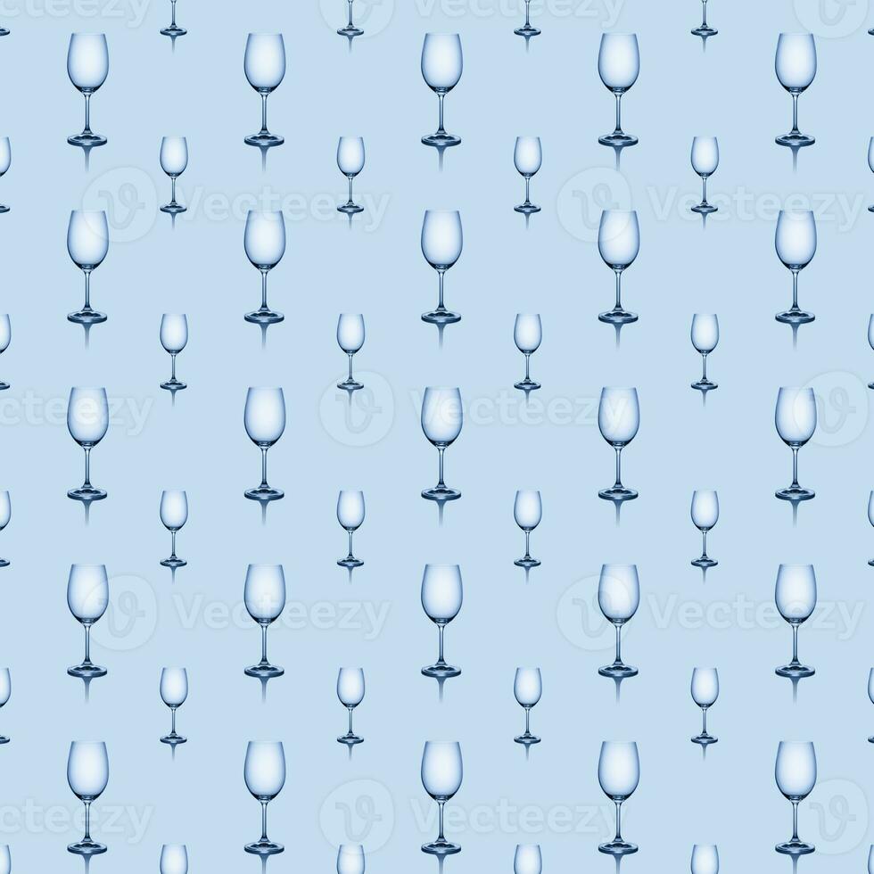 Seamless pattern of empty wine glasses on a blue background. photo