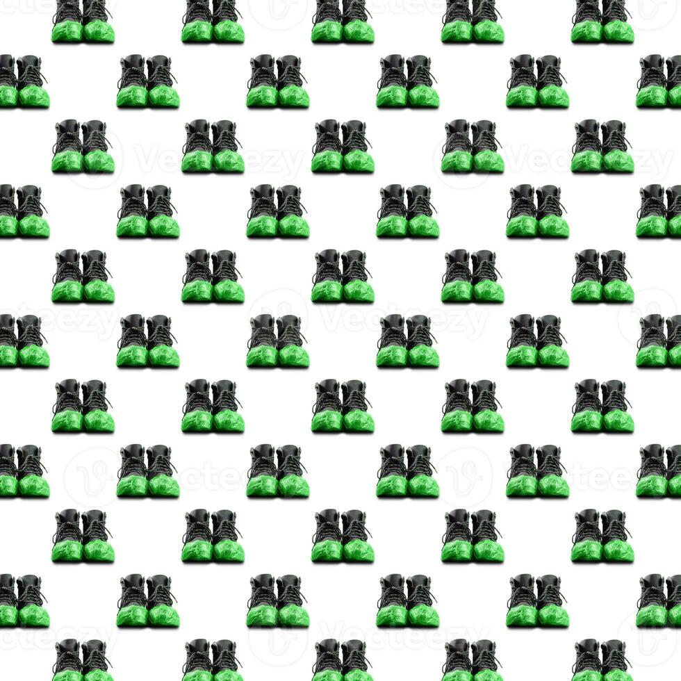 Seamless pattern of black leather mens shoes in green overshoes isolated on white background. photo