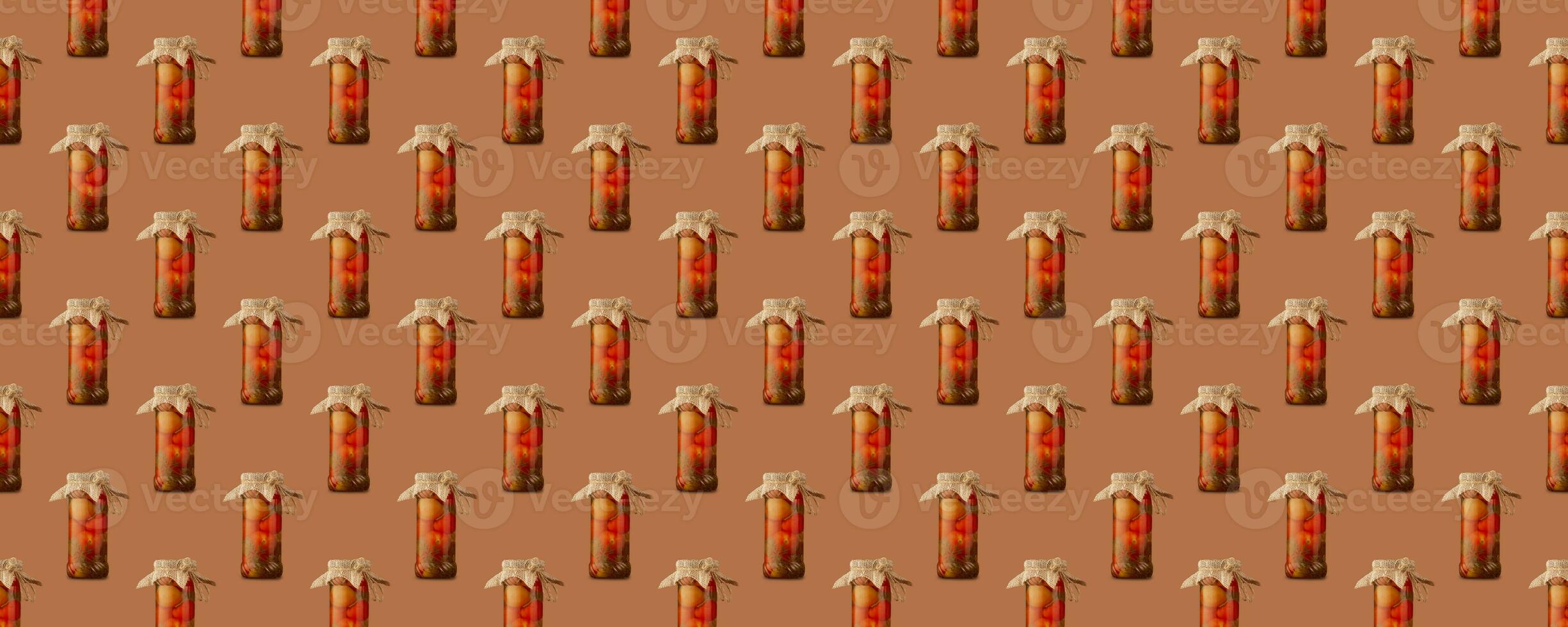 Seamless pattern of glass jars big and small with canned tomatoes is isolated on brown background. photo