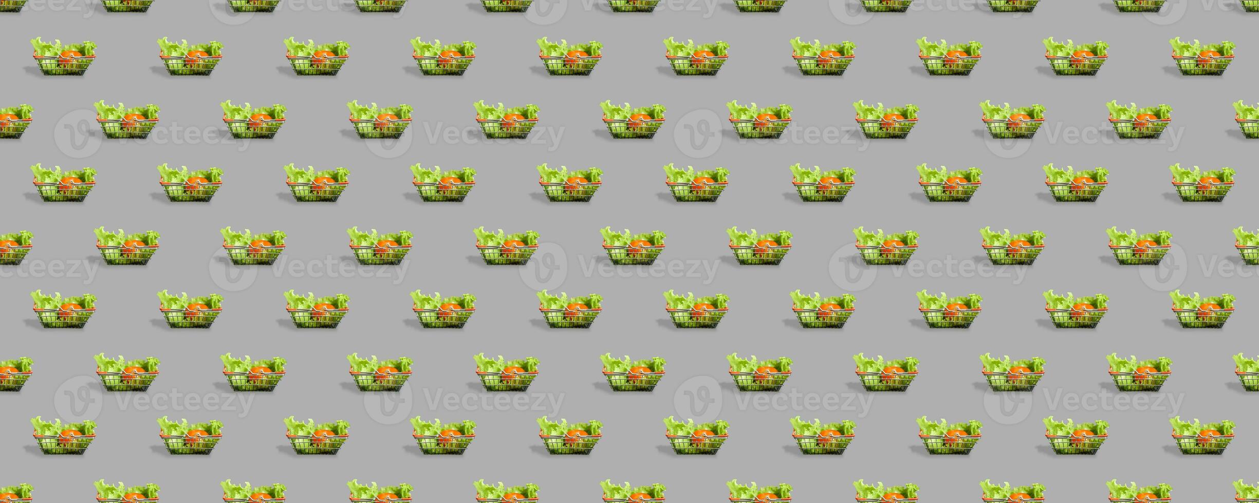 Fresh vegetables in a metal shopping cart. Seamless pattern of shopping baskets isolated on gray background. photo