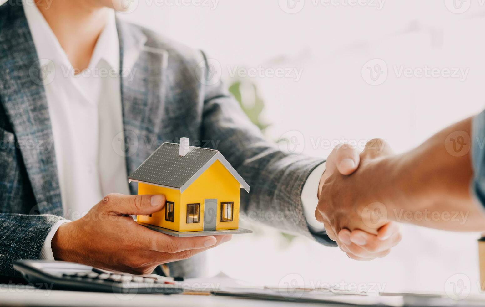 Real estate agent and customer signing contract to buy house, insurance or loan real estate.rent a house,get insurance or loan real estate or property. photo