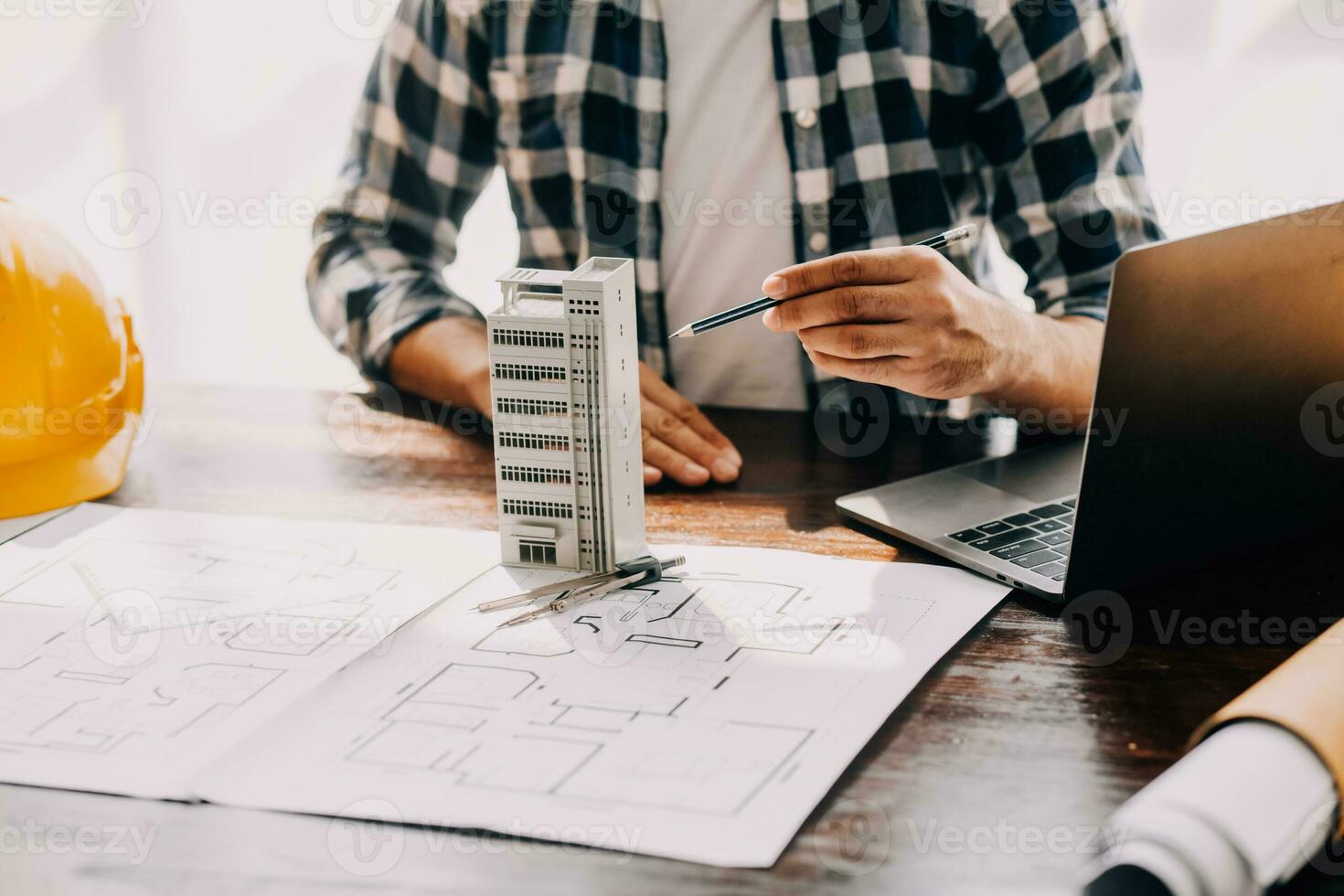 Construction and structure concept of engineer working drawing on blueprint meeting for project working with partner on model building and engineering tools in working site, construction concept. photo