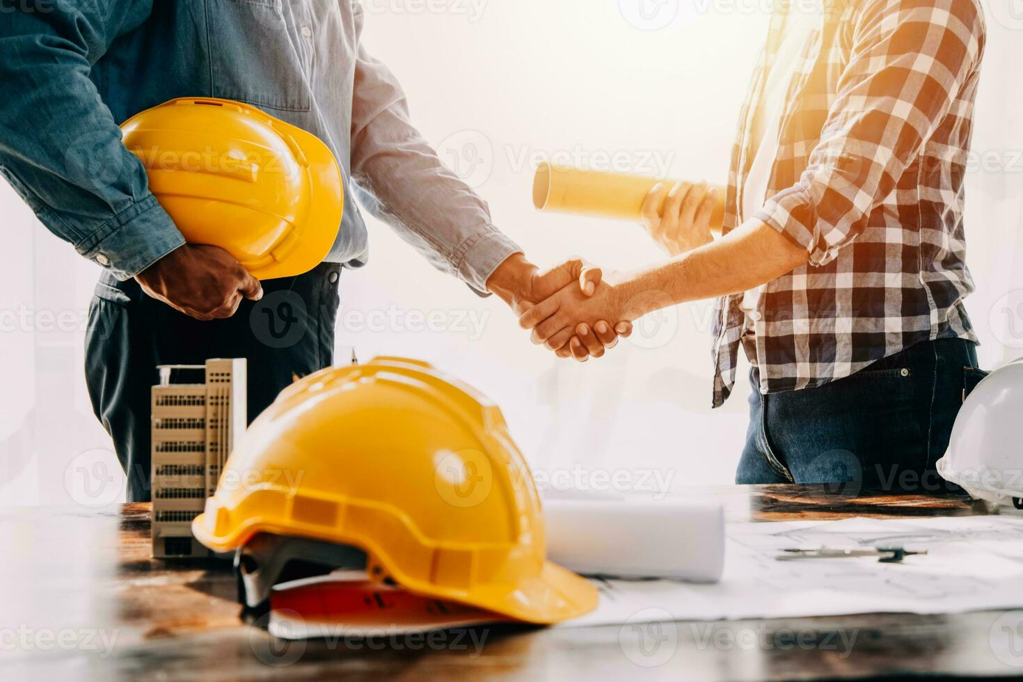 Construction and structure concept of engineer working drawing on blueprint meeting for project working with partner on model building and engineering tools in working site, construction concept. photo