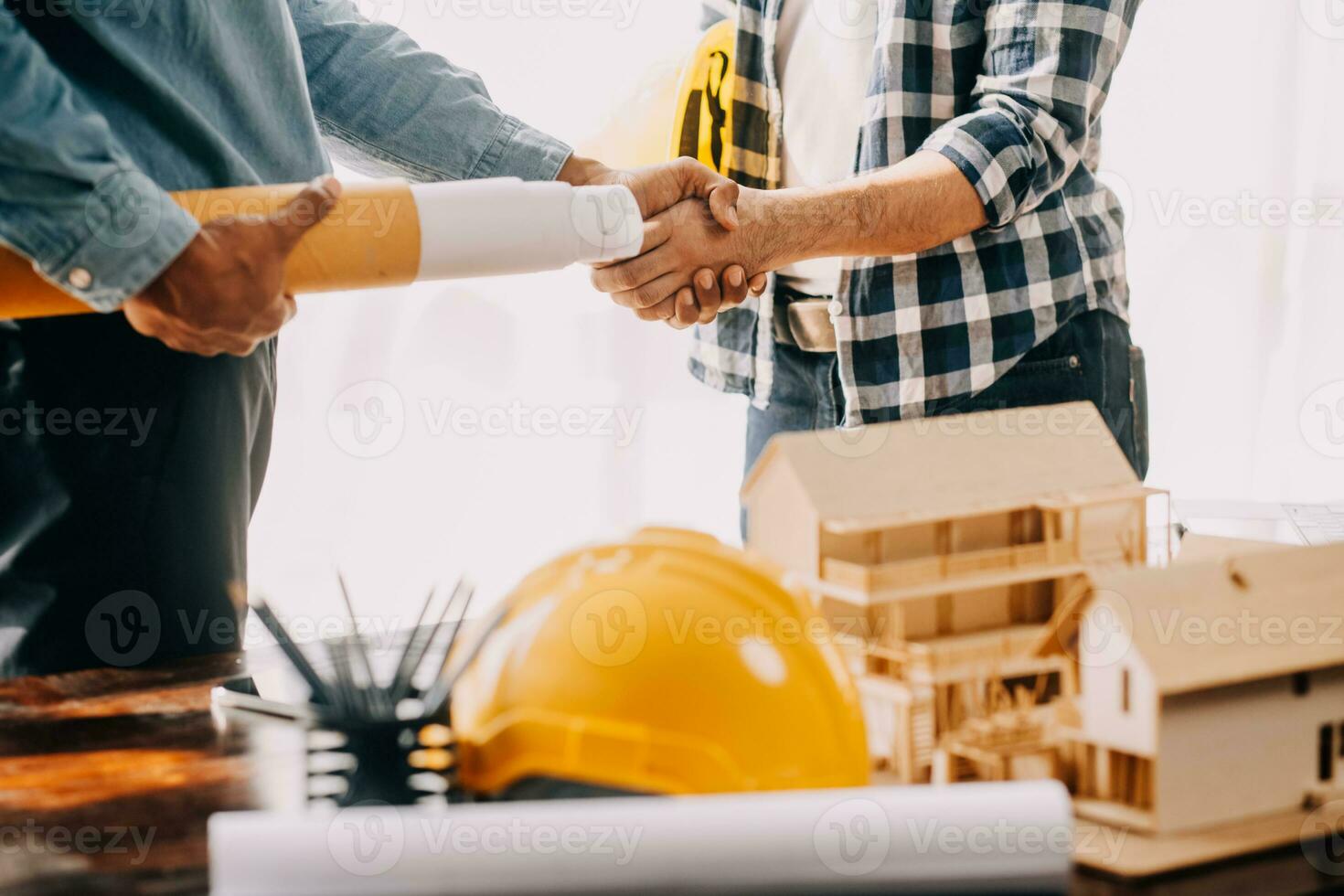 Construction and structure concept of engineer working drawing on blueprint meeting for project working with partner on model building and engineering tools in working site, construction concept. photo