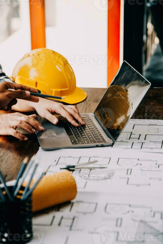 Construction and structure concept of engineer working drawing on blueprint meeting for project working with partner on model building and engineering tools in working site, construction concept. photo