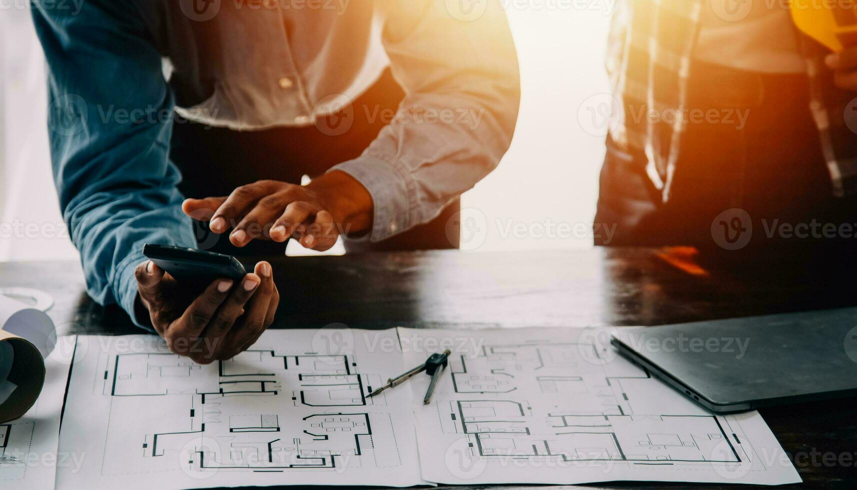 Construction and structure concept of engineer working drawing on blueprint meeting for project working with partner on model building and engineering tools in working site, construction concept. photo