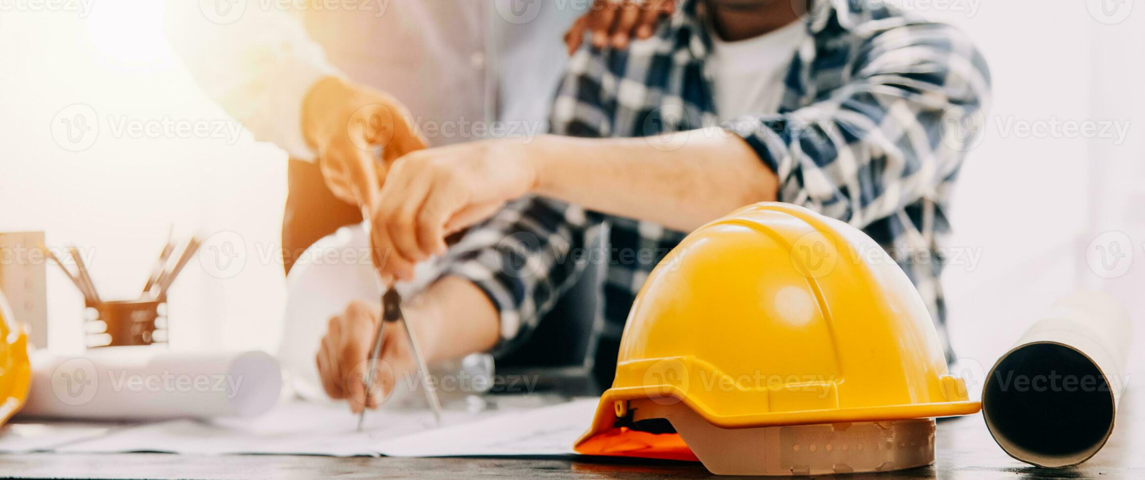 Construction and structure concept of engineer working drawing on blueprint meeting for project working with partner on model building and engineering tools in working site, construction concept. photo