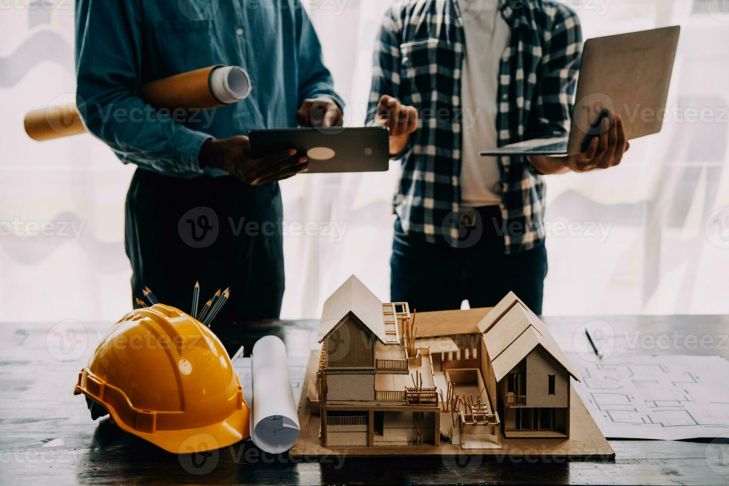 Construction and structure concept of engineer working drawing on blueprint meeting for project working with partner on model building and engineering tools in working site, construction concept. photo