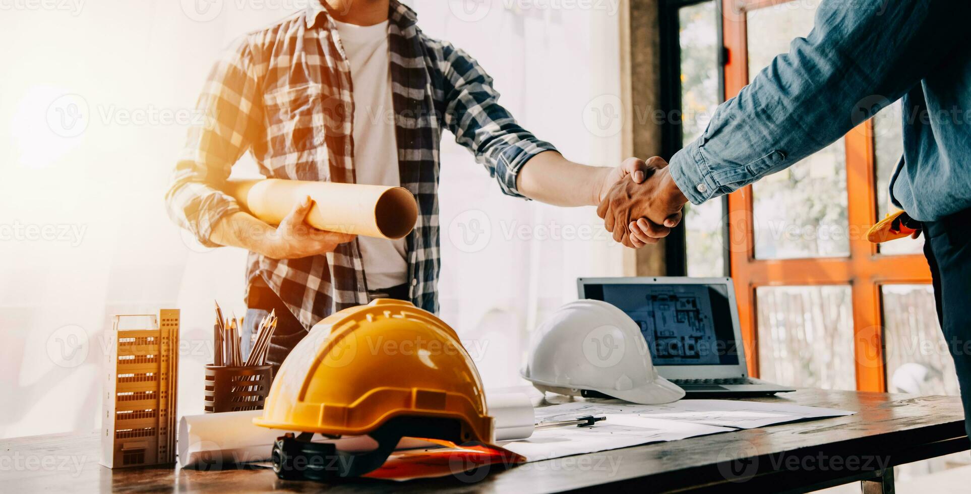 Construction and structure concept of engineer working drawing on blueprint meeting for project working with partner on model building and engineering tools in working site, construction concept. photo
