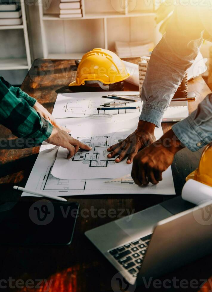 Construction and structure concept of engineer working drawing on blueprint meeting for project working with partner on model building and engineering tools in working site, construction concept. photo