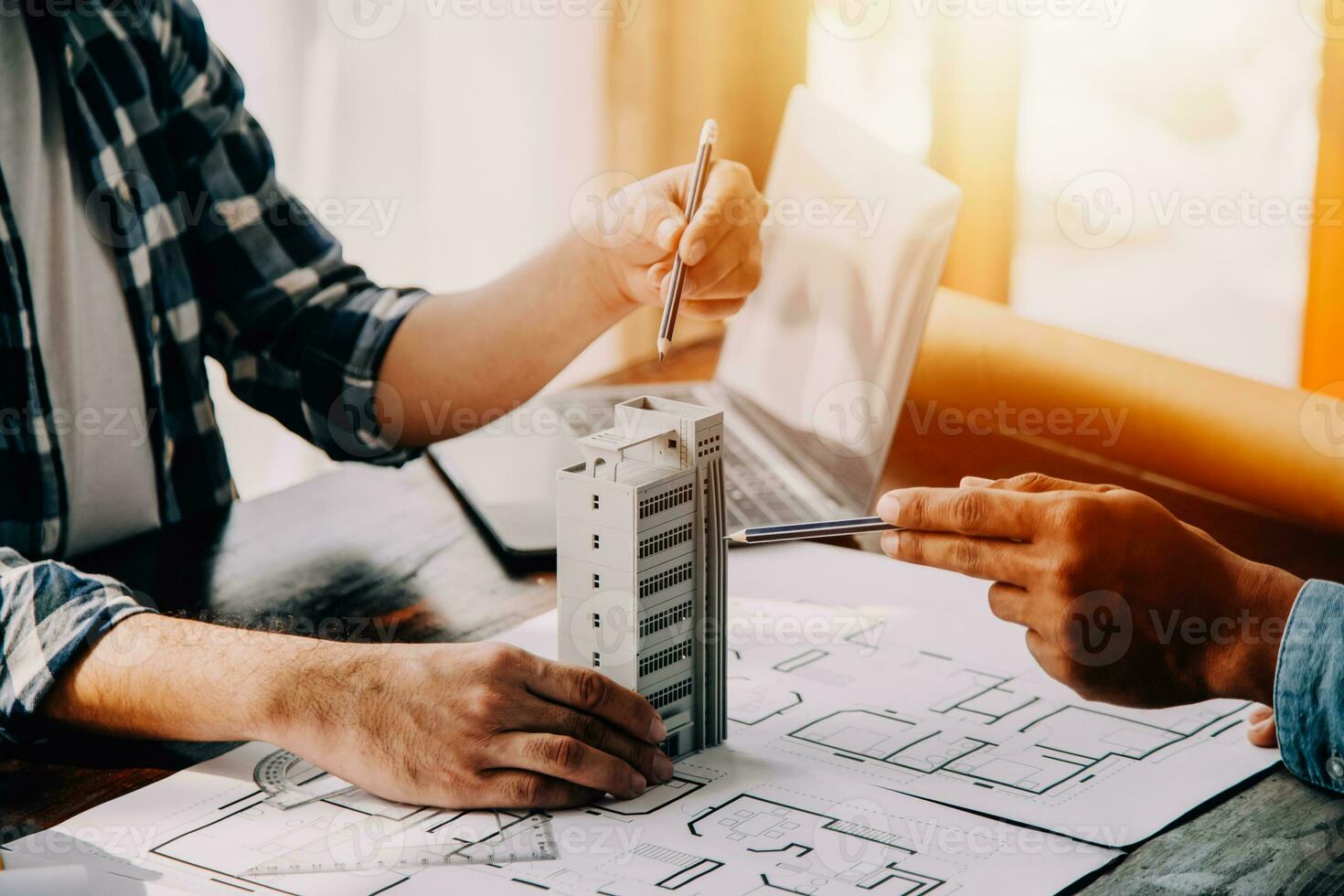 Construction and structure concept of engineer working drawing on blueprint meeting for project working with partner on model building and engineering tools in working site, construction concept. photo