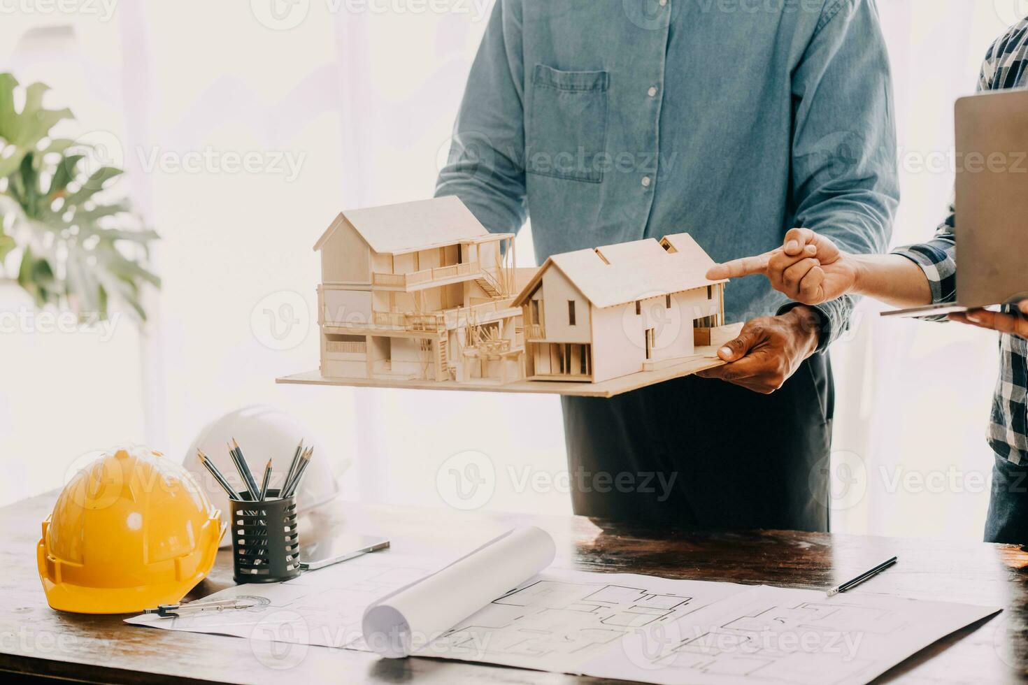 Construction and structure concept of engineer working drawing on blueprint meeting for project working with partner on model building and engineering tools in working site, construction concept. photo