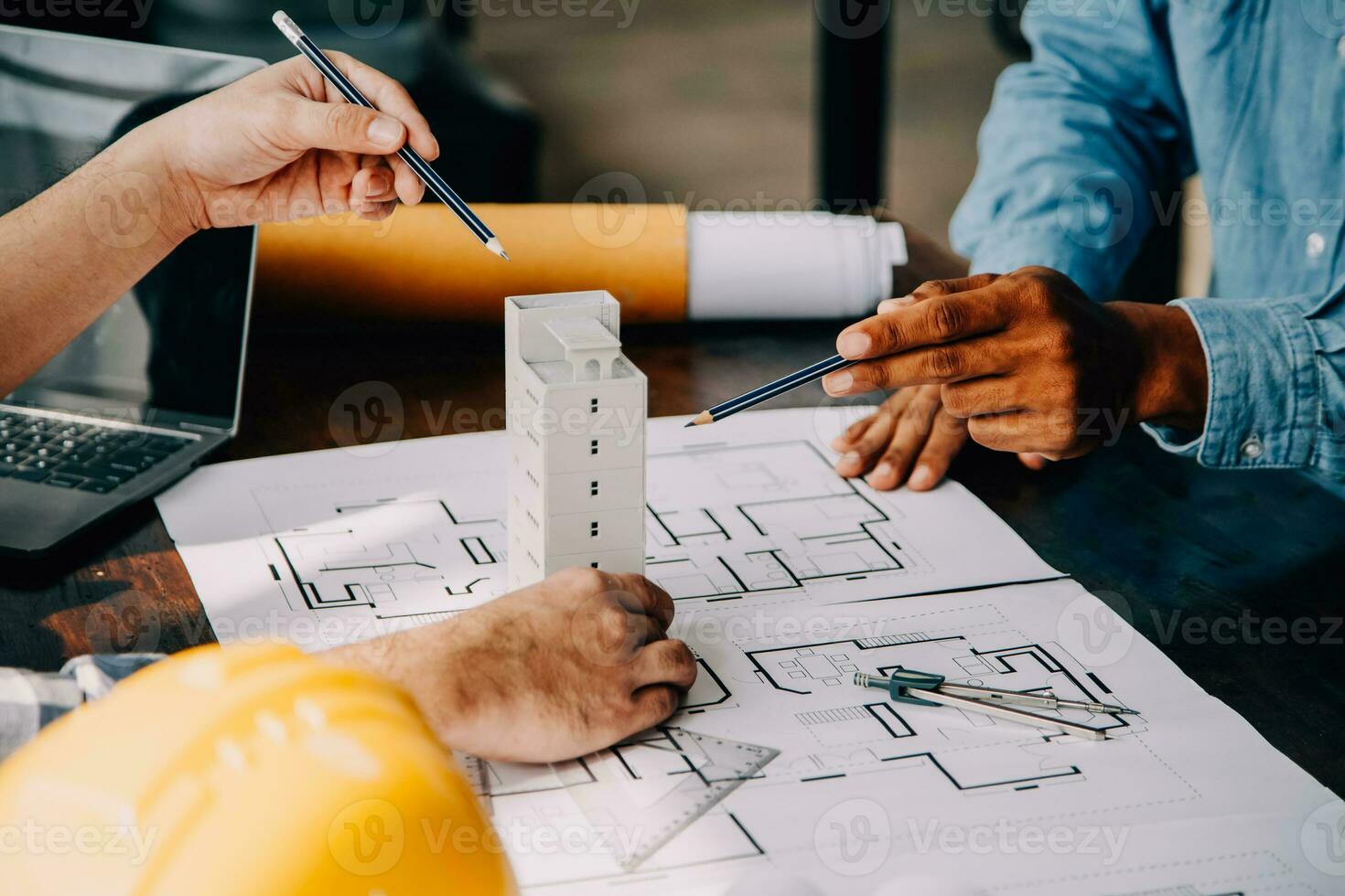 Construction and structure concept of engineer working drawing on blueprint meeting for project working with partner on model building and engineering tools in working site, construction concept. photo