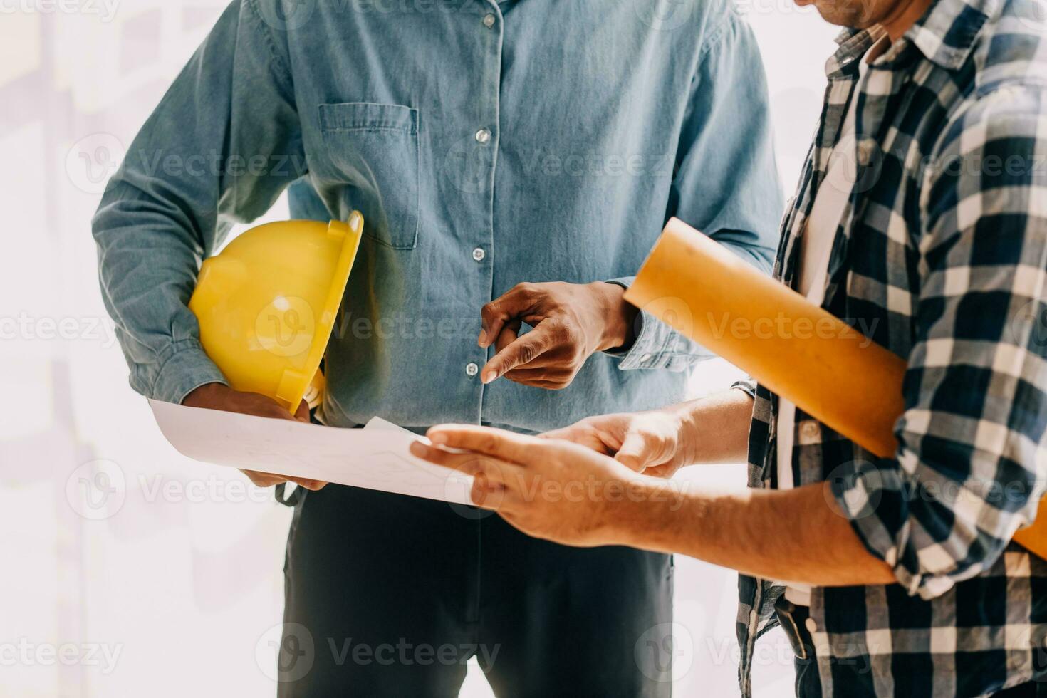 Construction and structure concept of engineer working drawing on blueprint meeting for project working with partner on model building and engineering tools in working site, construction concept. photo