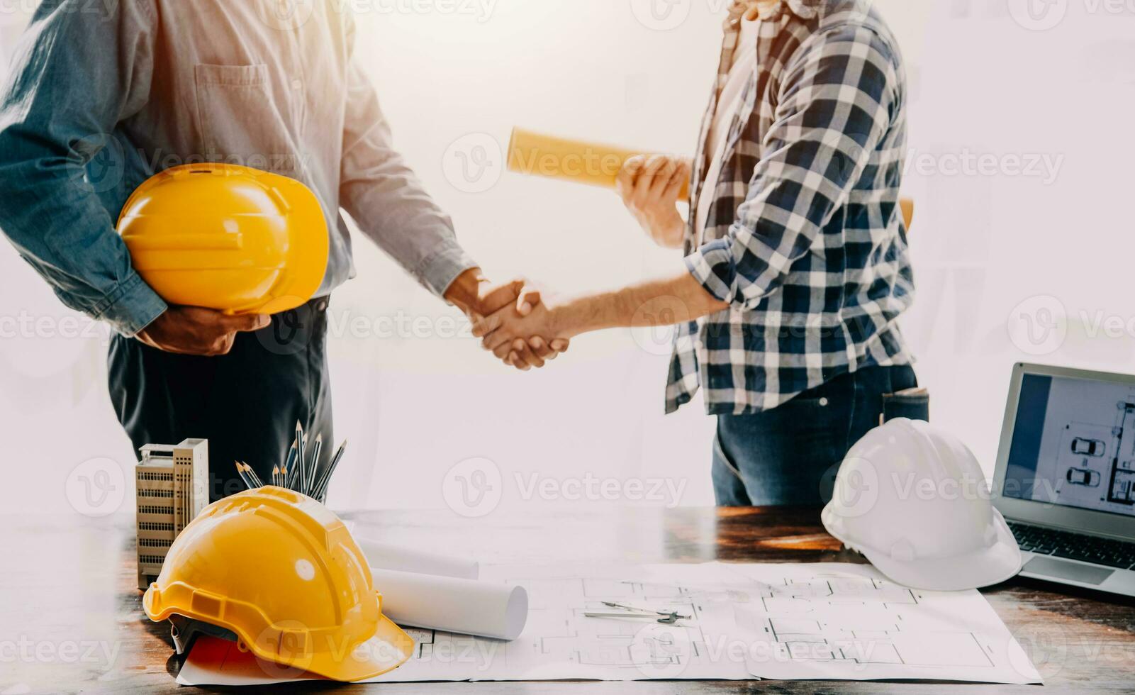 Construction and structure concept of engineer working drawing on blueprint meeting for project working with partner on model building and engineering tools in working site, construction concept. photo