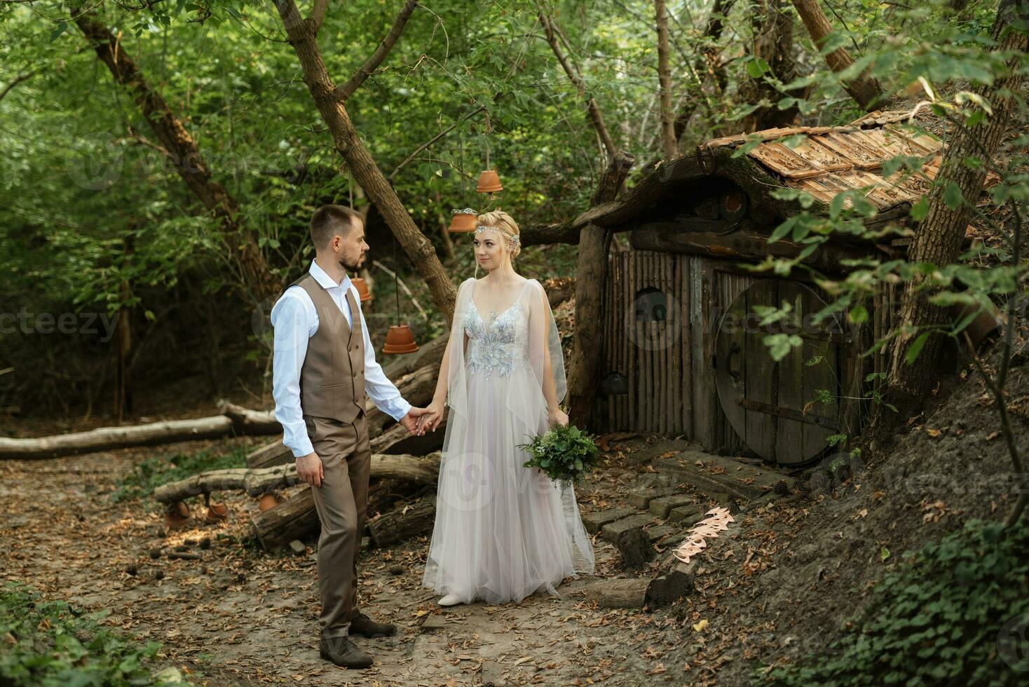 wedding walk of the bride and groom in a coniferous in elven accessories photo