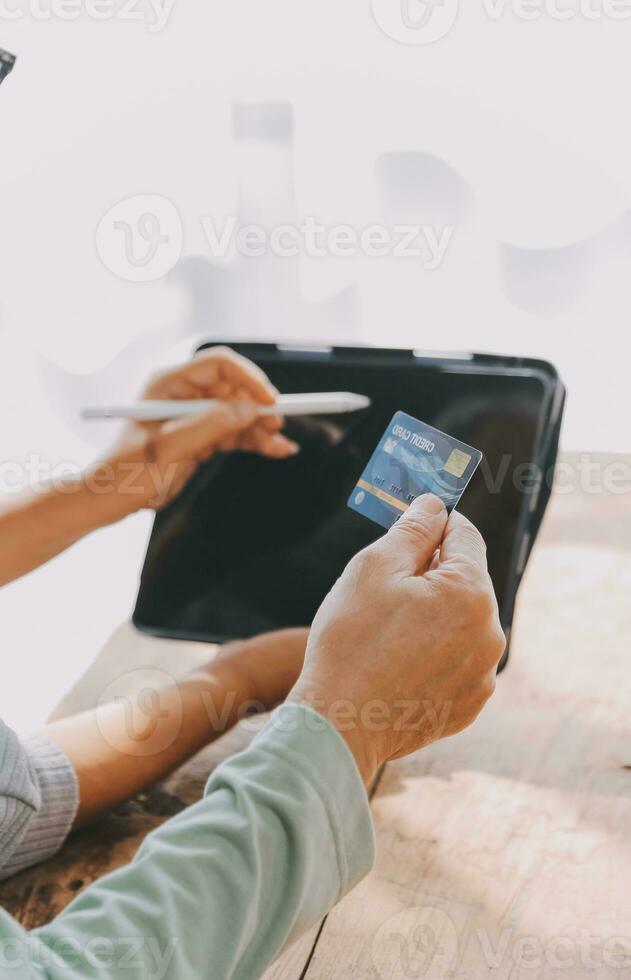 Close up mature man holding plastic credit card, senior couple family paying online, using laptop, satisfied older customers making secure internet payment, shopping, browsing banking service photo