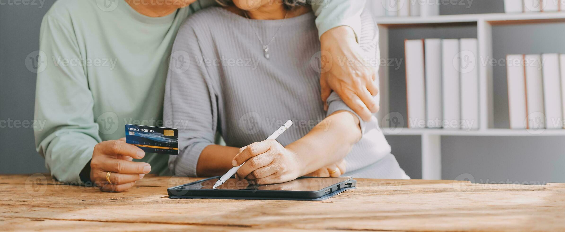 Close up mature man holding plastic credit card, senior couple family paying online, using laptop, satisfied older customers making secure internet payment, shopping, browsing banking service photo