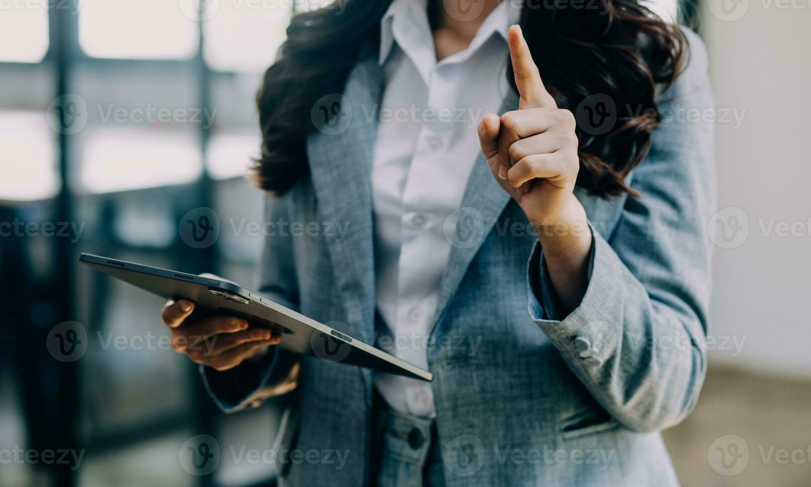 Asian Business woman using calculator and laptop for doing math finance on an office desk, tax, report, accounting, statistics, and analytical research concept photo